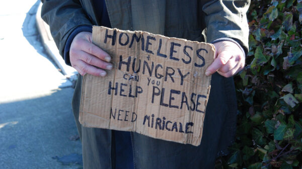 homeless man holding sign asking for help