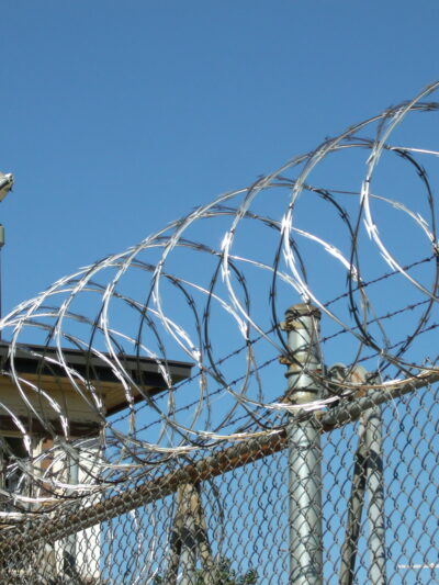 razor wire coiled along top of prison fence