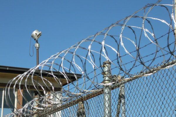 razor wire coiled along top of prison fence