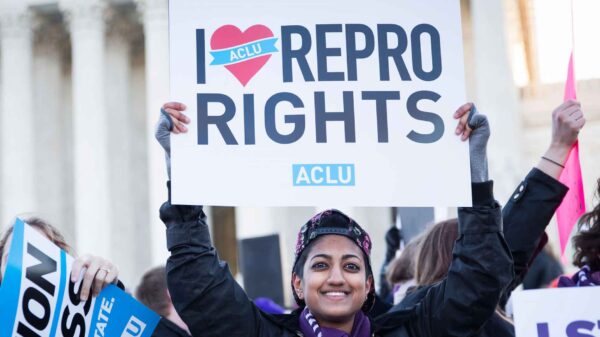 woman holding sign reading i heart repro rights
