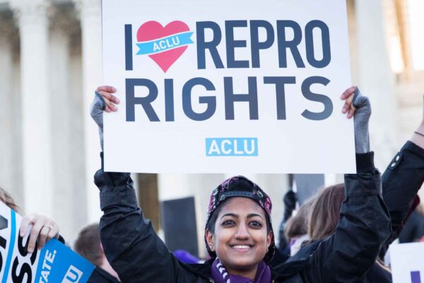woman holding sign reading i heart repro rights