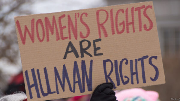 hand holding up sign saying women's rights are human rights