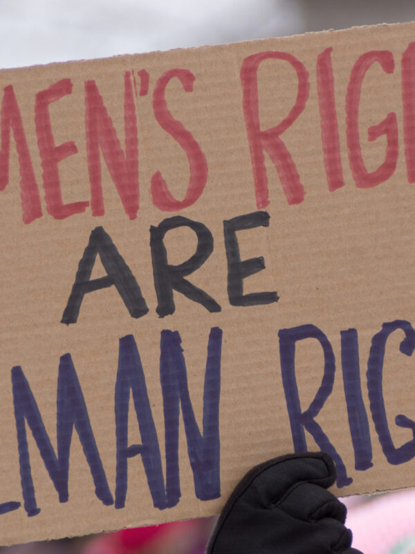 hand holding up sign saying women's rights are human rights