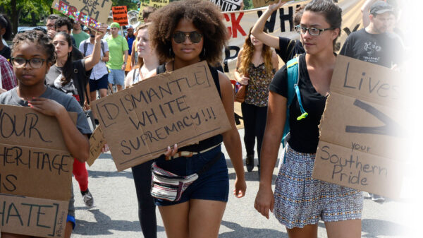 Three women protesting confederate monuments
