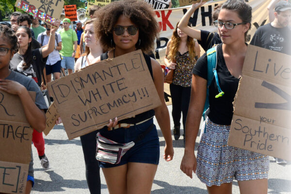 Three women protesting confederate monuments