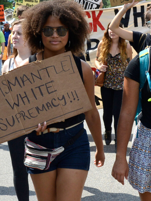 Three women protesting confederate monuments