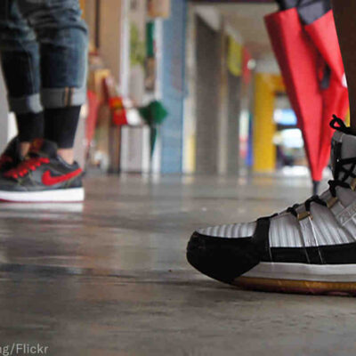 two people wearing nike sneakers