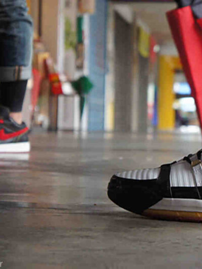 two people wearing nike sneakers