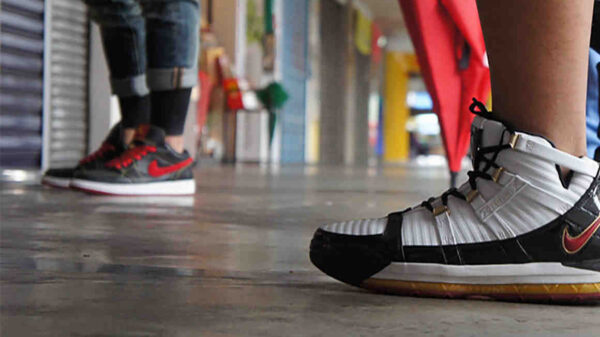 two people wearing nike sneakers