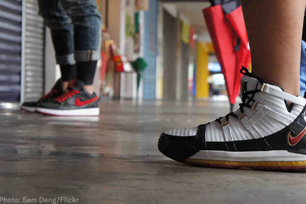 two people wearing nike sneakers