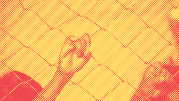 A child's hand on a chain link fence