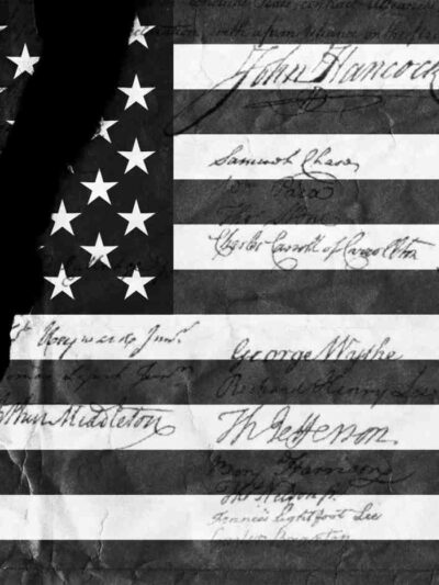 An American flag with a tear through it