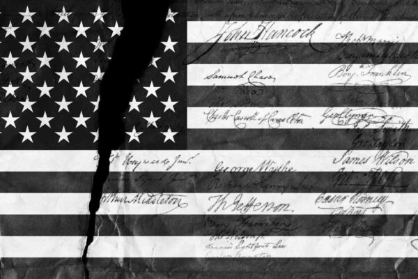 An American flag with a tear through it