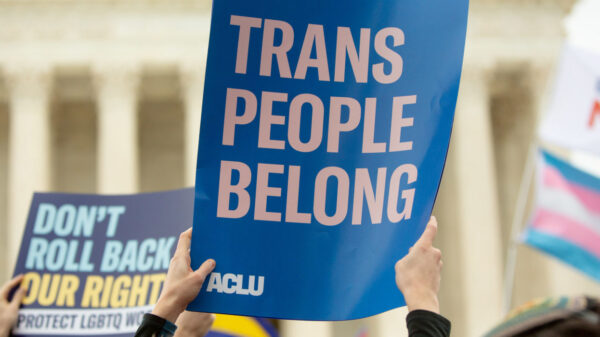 A rally sign reading Trans People Belong