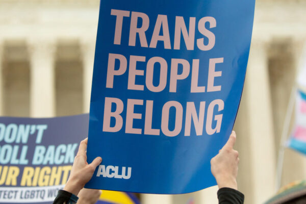 A rally sign reading Trans People Belong