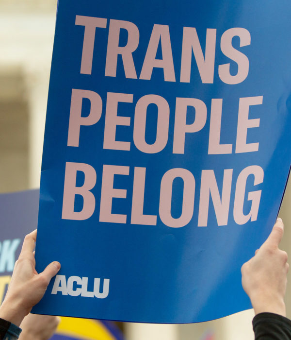 A rally sign reading Trans People Belong