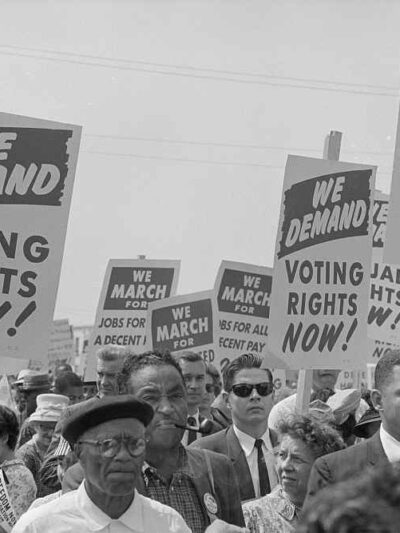 Voting Rights advocates hold signs at The March on Washington, 1963
