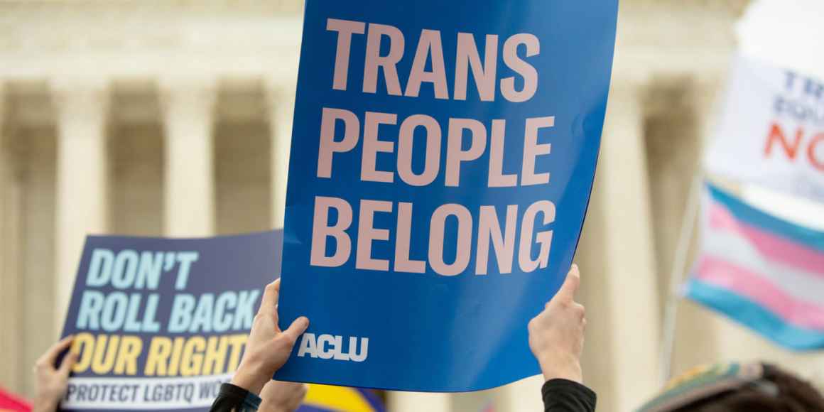 A rally sign reading Trans People Belong