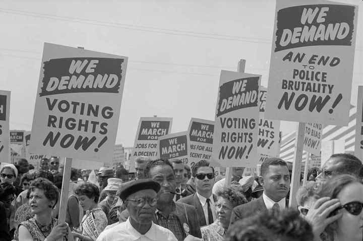 Voting Rights advocates hold signs at The March on Washington, 1963
