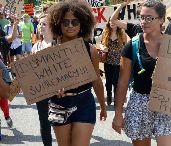 Three women protesting confederate monuments